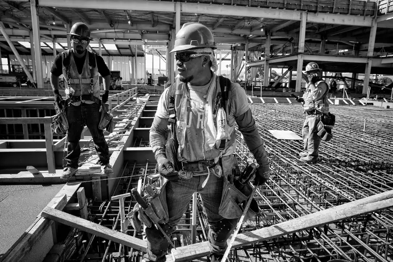 A man and a woman smiling at a desk