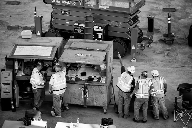 A man and a woman smiling at a desk