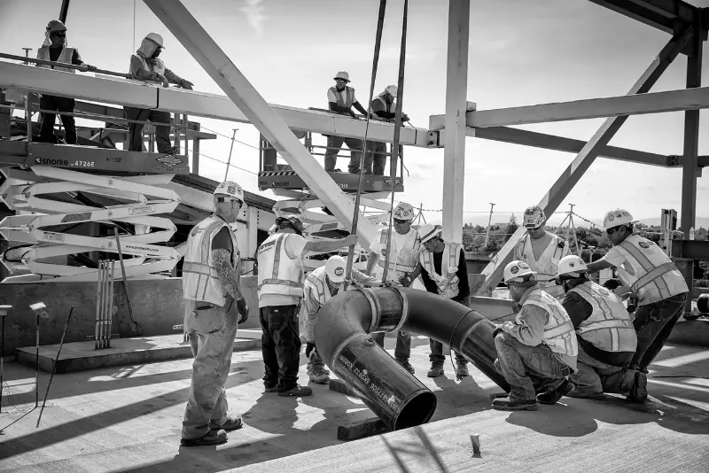 A man and a woman smiling at a desk