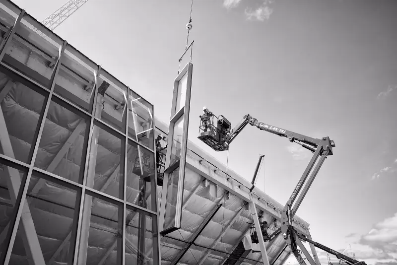 A man and a woman smiling at a desk